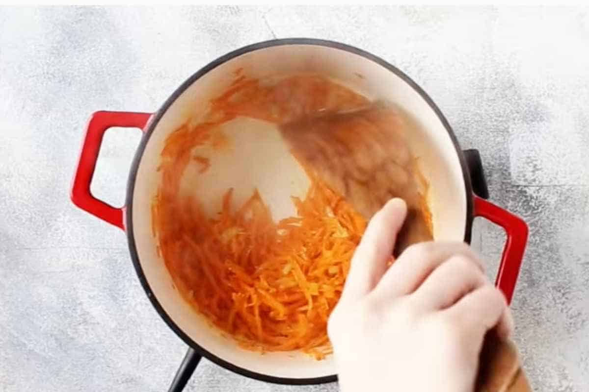 cook onion and shredded carrot with butter in a pan