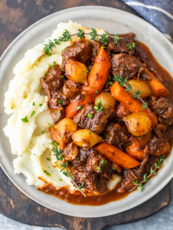 Beef Bourguignon is a delicious beef stew that's perfect for winter meals. Also known as beef burgundy or boeuf bourguignon, this dish is hearty and filling. This beef bourguignon recipe is made with beef, red wine, beef broth, and lots of vegetables. Serve this beef burgundy stew with mashed potatoes, egg noodles, rice, or all on its own. It's delicious no matter what!