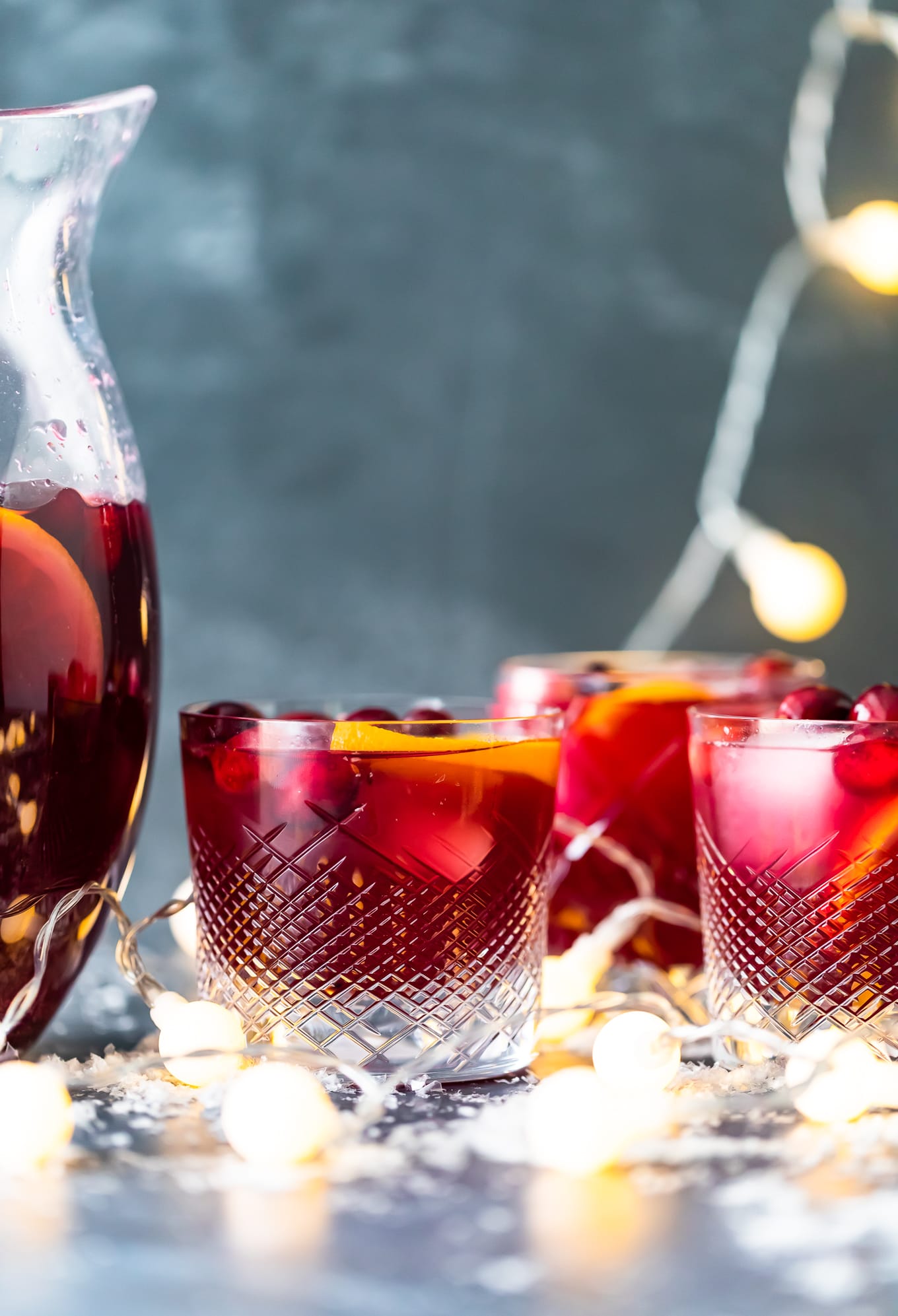 glasses of Christmas sangria with Christmas lights in the background