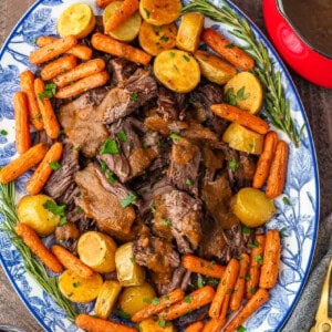 A plate of Christmas pot roast with carrots and gravy.