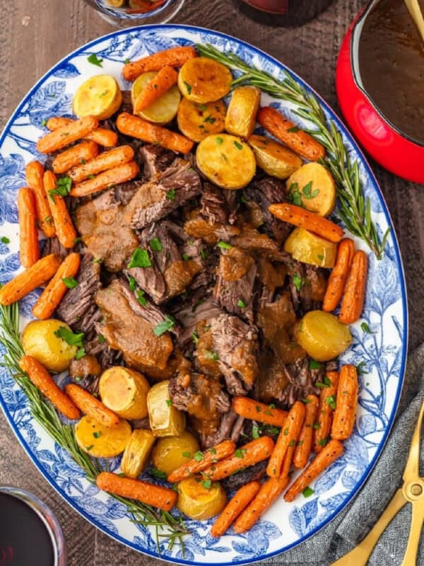 A plate of Christmas pot roast with carrots and gravy.