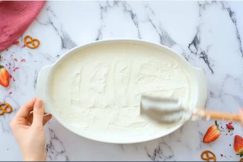 Pour the cream cheese mixture over the pretzel crust and use a spoon or offset spatula to make a smooth layer