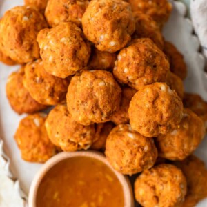 This Sausage Cheese Balls recipe puts a sweet and spicy twist on a classic appetizer. These easy sausage balls are made with cheese, sweet potato, and chorizo, and they taste amazing! Dip these Sweet Potato Sausage Balls in a spicy marmalade sauce for the final touch.