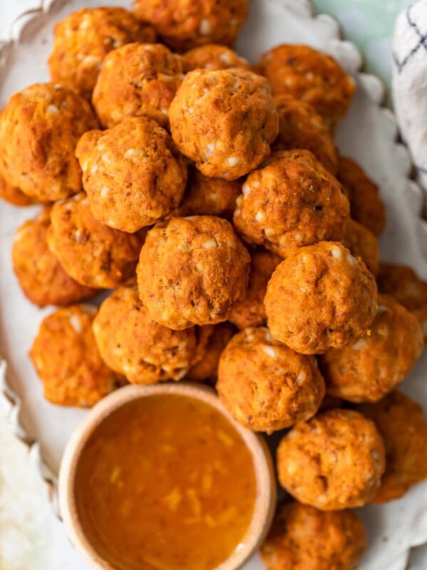 This Sausage Cheese Balls recipe puts a sweet and spicy twist on a classic appetizer. These easy sausage balls are made with cheese, sweet potato, and chorizo, and they taste amazing! Dip these Sweet Potato Sausage Balls in a spicy marmalade sauce for the final touch.