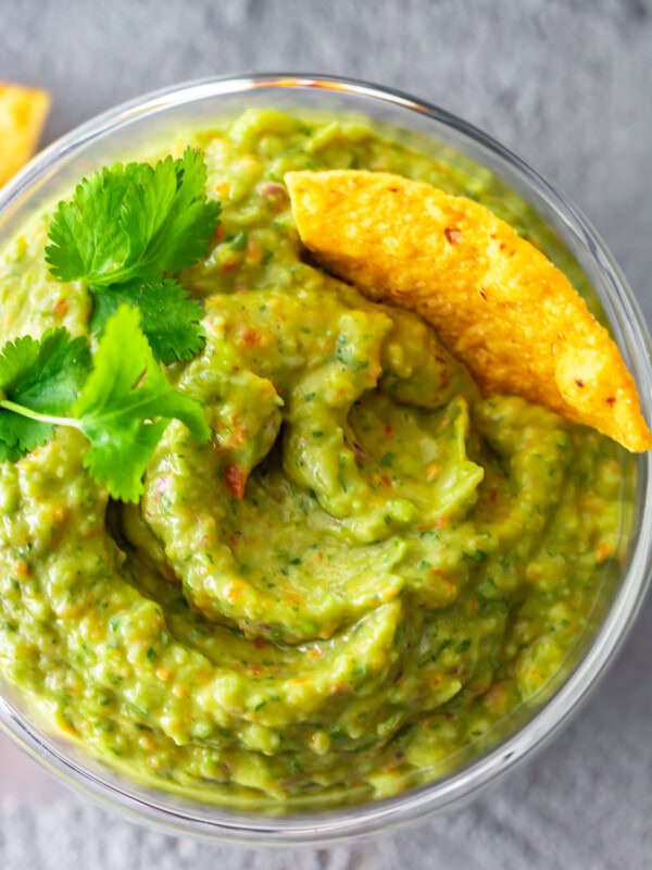 Easy Guacamole Recipe...I've never heard three words sound more beautiful! This simple and delicious Food Processor Guacamole is filled with great ingredients, and only takes a few minutes to make. No chunks here, just smoooooth guac!