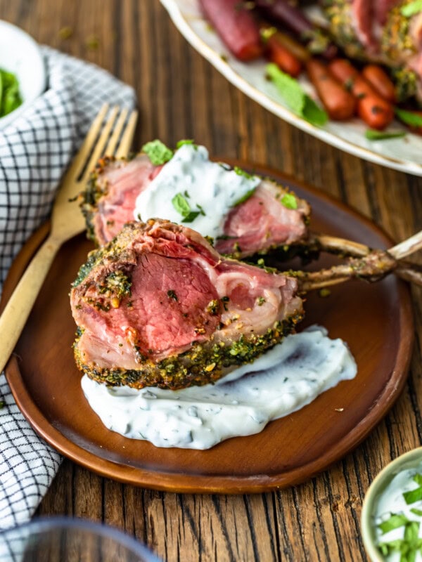 Rack of Lamb is an elegant option for holidays and special occasions. This delicious Herb Crusted Rack of Lamb recipe is simple yet filled with incredible flavor! The Mint Yogurt Sauce is the perfect compliment to the savoriness of this dish. Try this roast rack of lamb for a beautiful Easter Dinner!