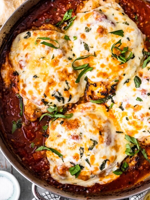 Chicken Parmesan is a classic dish that seems to be loved by all. This crispy chicken parm is the BEST Chicken Parmesan recipe ever. It's so easy and so delicious. Make it for an easy weeknight dinner, or a special occasion!