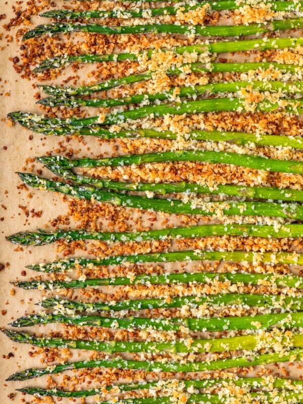 Garlic Asparagus is an easy side dish for any meal. This CRISPY garlic roasted asparagus recipe is both healthy and flavorful. Baked with panko breadcrumbs, garlic, cheese, and olive oil, this is a dish everyone is sure to love. If that's not enough, our garlic parmesan asparagus is topped off with homemade garlic aioli!