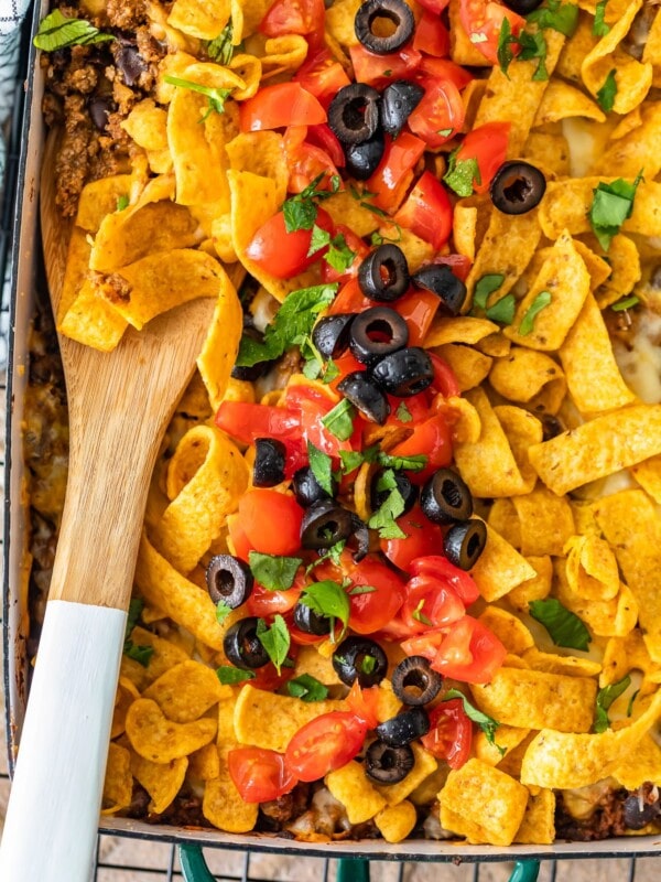 Frito Pie Casserole is an easy recipe with all the best Tex Mex flavors! Layer up the corn chips, beef, cheese, and more in a delicious dish that's perfect for weeknight dinners. Everyone will LOVE this Frito Pie recipe!