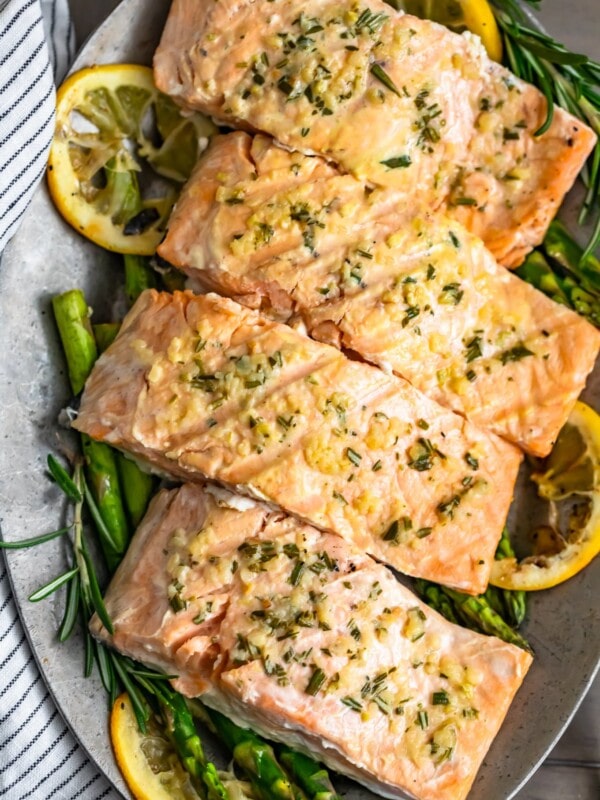 Garlic Butter Salmon is a simple and healthy dish you'll want to be making all summer long! This easy grilled salmon recipe is one of the best and most flavorful. The garlic lemon butter salmon is so light and tasty, and it is just perfect paired with our grilled lemon butter asparagus!