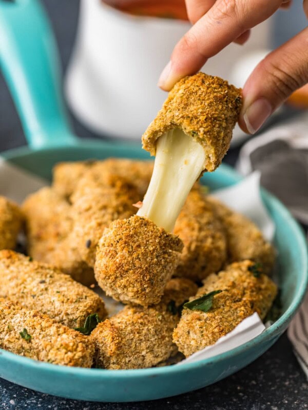 baked mozarella stick being pulled apart