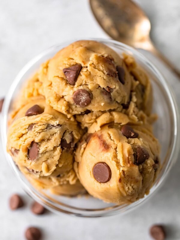 a top view of scooped chocolate chip edible cookie dough in a bowl