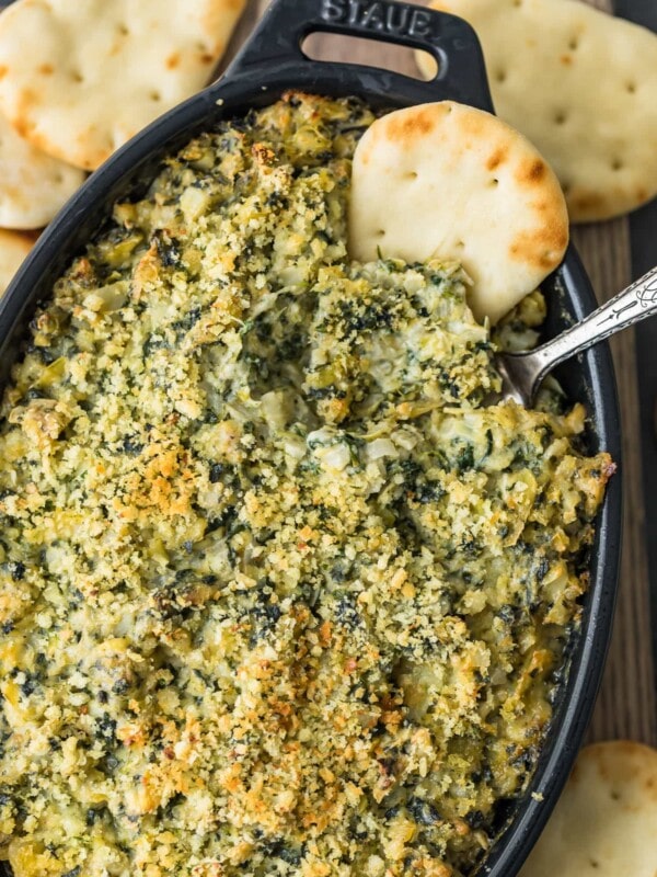 spinach dip in casserole dish with chip