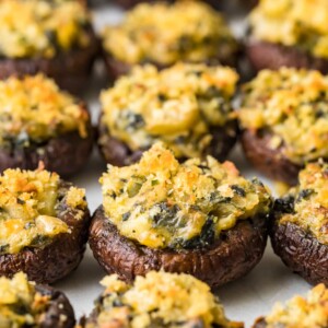 stuffed mushrooms lined up on a sheet