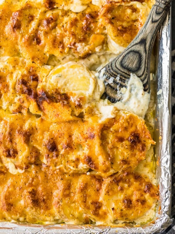 sheet pan scalloped potatoes in a pan with spoon