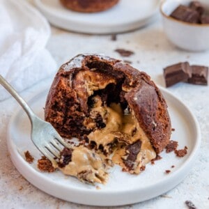 peanut butter chocolate lava cake on white plate with a fork