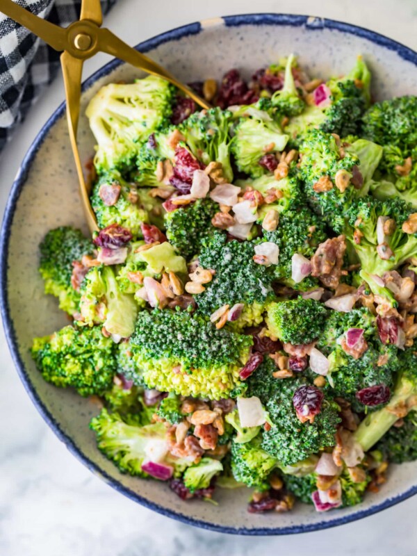 broccoli salad with bacon in a bowl and tongs