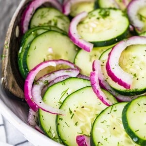 cucumber salad in a white bowl