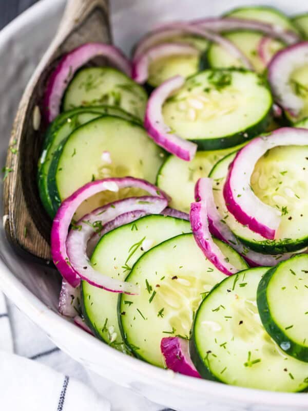 cucumber salad in a white bowl