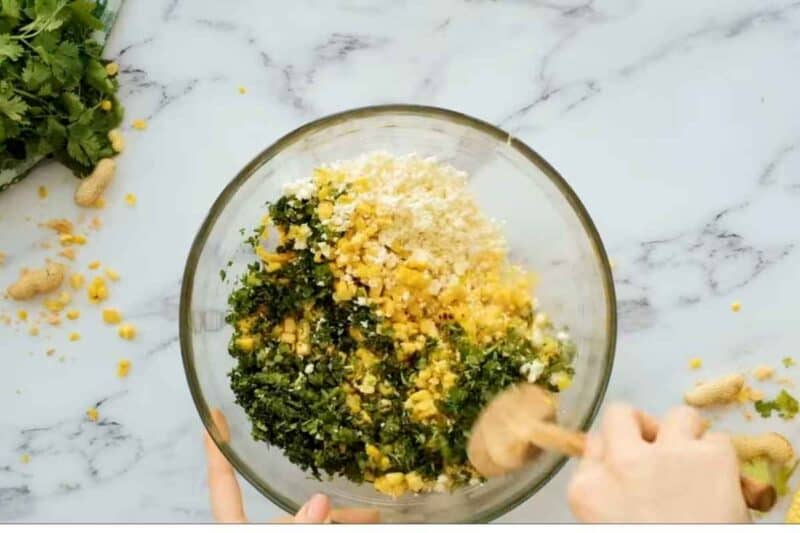 mix in herbs, cheese, jalapeno with all corn kernels in a glass bowl.