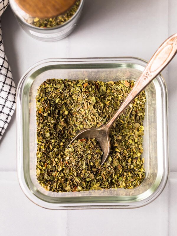 homemade italian seasoning in a jar with spoon