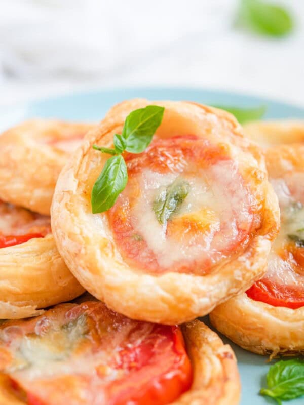 caprese tarts stacked on a plate