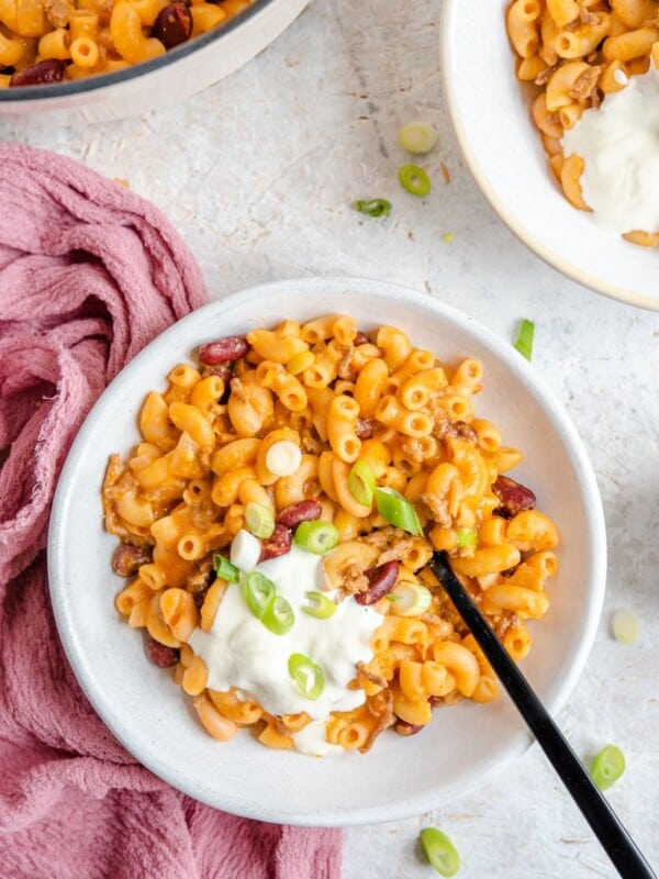 loaded chili mac and cheese in a white bowl