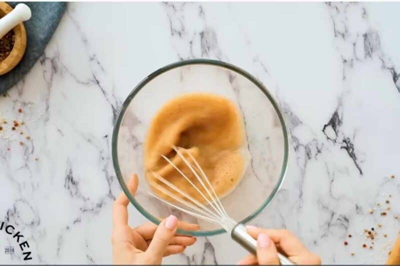 whisking egg whites with spice to make the coating.