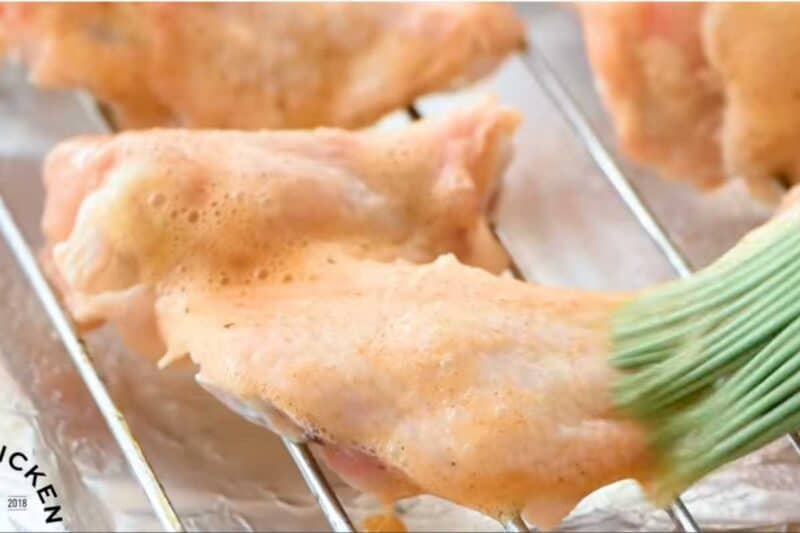 brush egg white mixture on chicken wings from both sides.