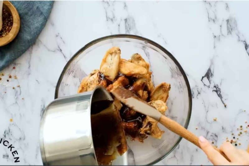 combine baked chicken and honey glaze in a glass bowl