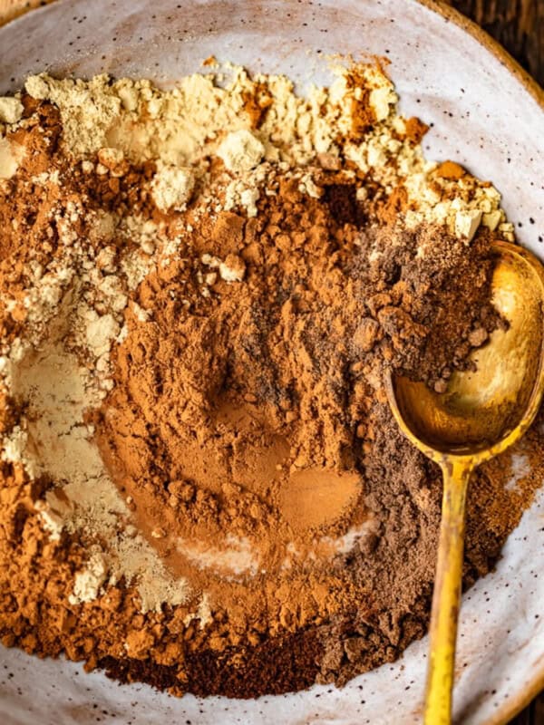 Chocolate powder sprinkled in a bowl with a spoon.