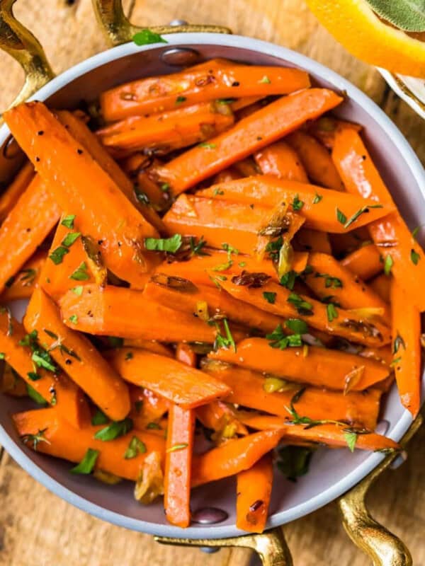 Sauteed carrots with thyme and oranges in a bowl.