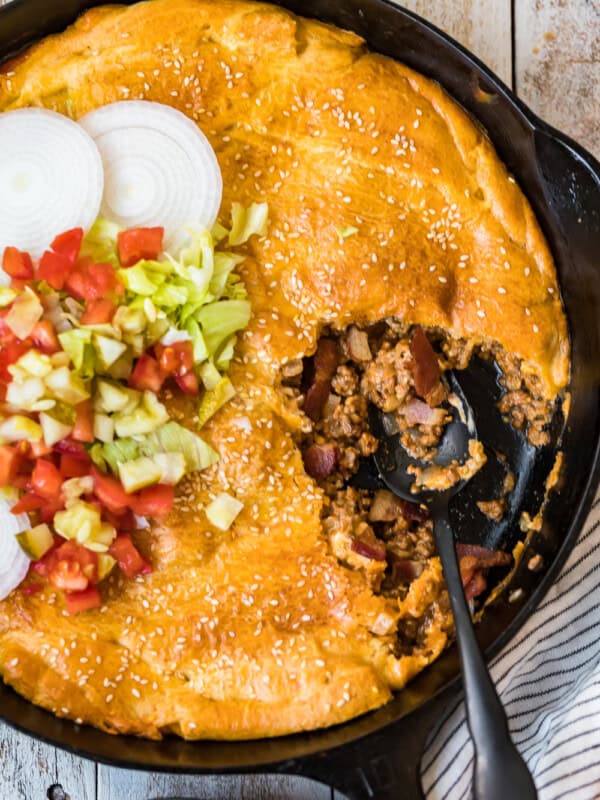 bacon cheeseburger pot pie in a skillet with spoon