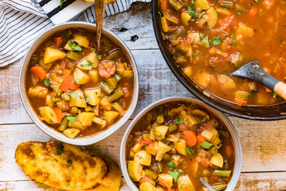 Vegetable soup bowls on a wooden table.