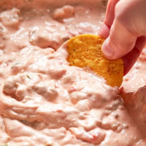 dipping chip into crockpot sausage cream cheese dip