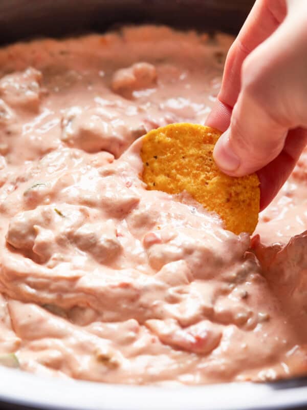 dipping chip into crockpot sausage cream cheese dip