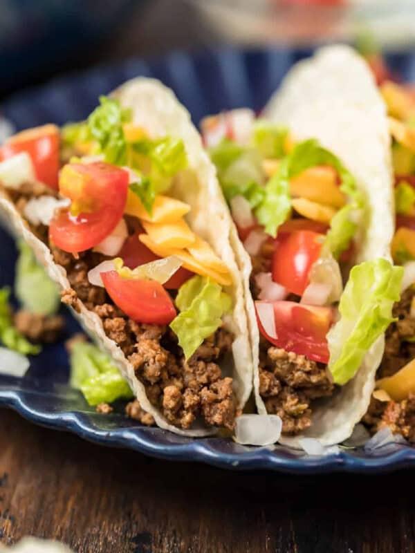 A plate of tacos with crockpot taco meat and vegetables.