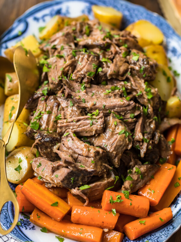 slow cooker pot roast on plate with carrots and potatoes