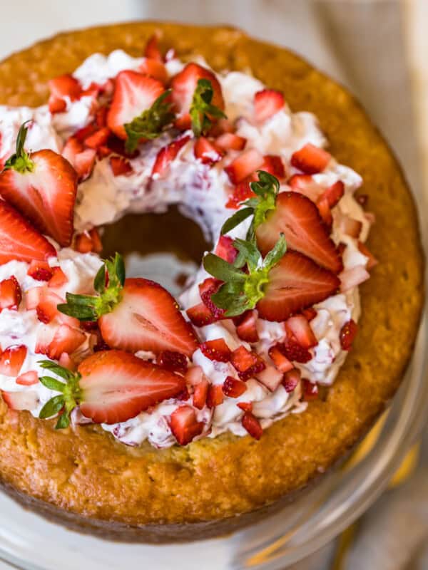 butter cake and strawberries and cream on a cake plate