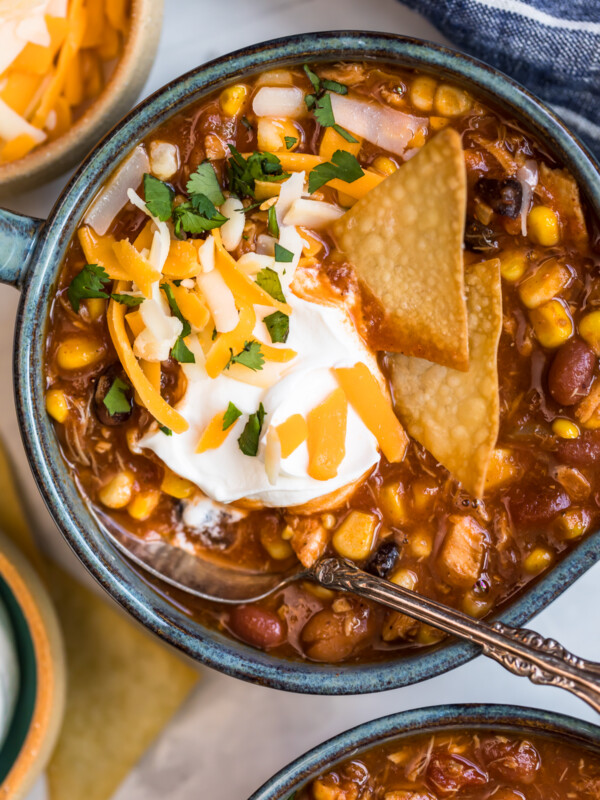 chicken taco soup in a bowl with chips and sour cream garnish