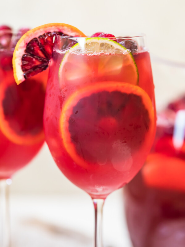 non alcoholic sangria in a wine glass with citrus garnishes