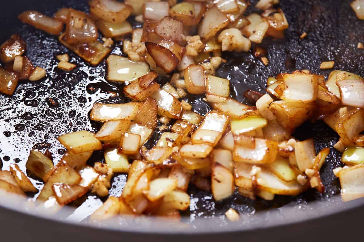 Onions cooking in a pan.