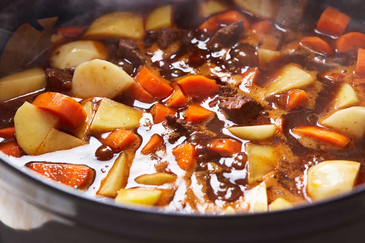 Red wine beef stew cooking in a pot.