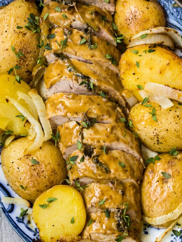 up close image of honey mustard pork tenderloin with potatoes on platter