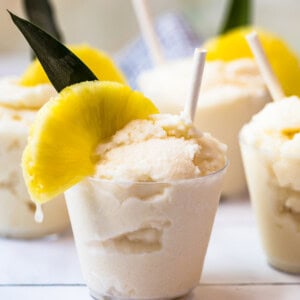 creamy frozen pina coladas in glasses garnished