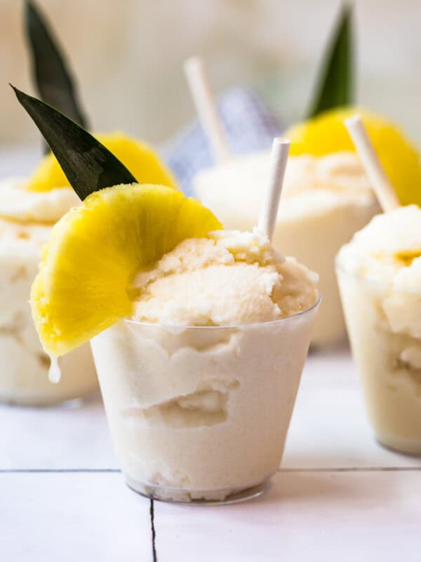 creamy frozen pina coladas in glasses garnished