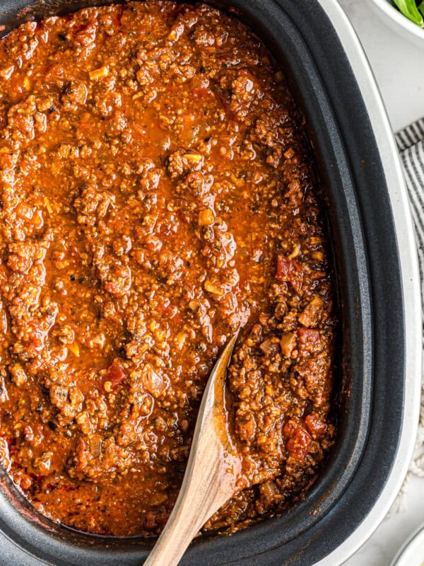 wooden spoon in spaghetti sauce in slow cooker