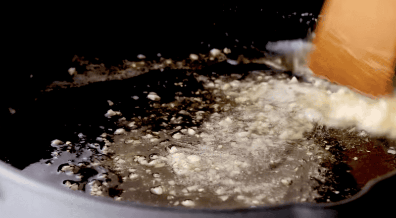 sauce with minced garlic in a pan.