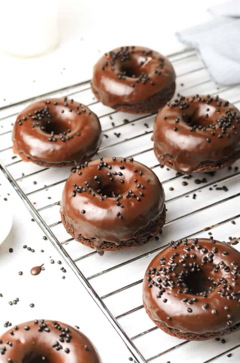 chocolate donuts on cooling rack
