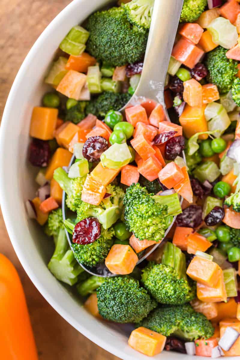 bowl with broccoli salad and wooden spoon